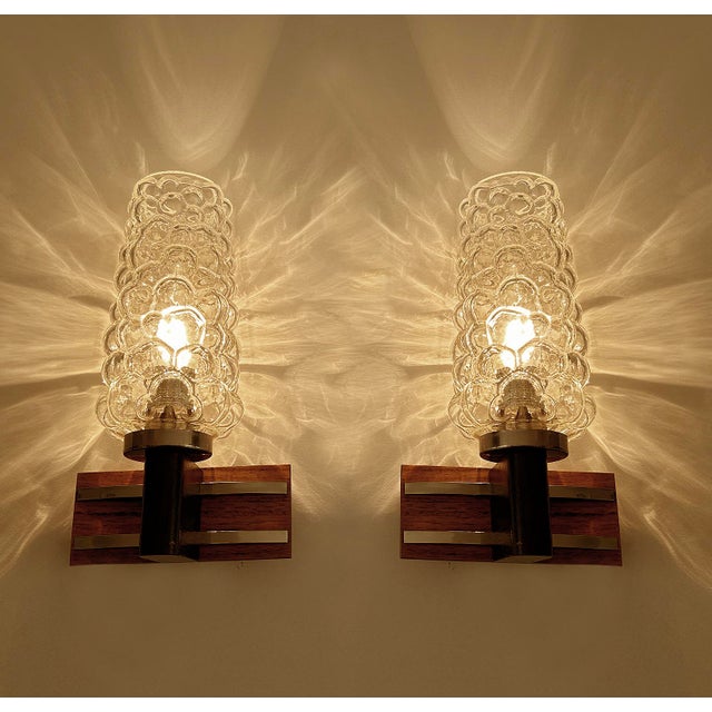 Pair Vintage Danish modern style sconces featuring a brass stucture with a teak wood structure with chrome banding and...
