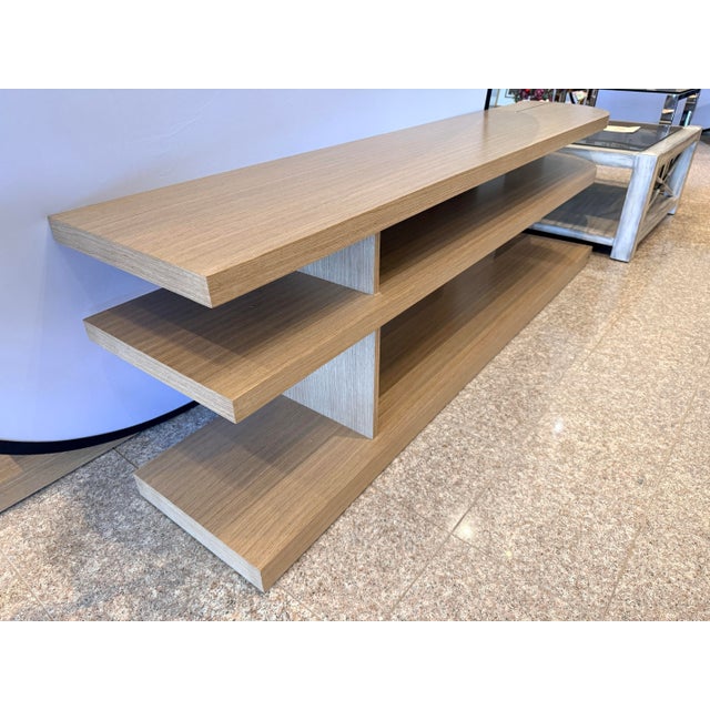 Sleek, asymmetrical, and highly functional, this modern Bernhardt console offers a fresh take on media storage or open...