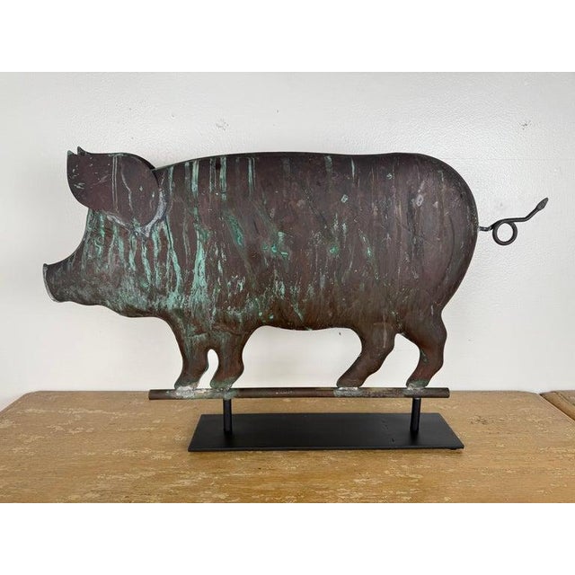 A charming and highly sculptural antique copper pig weathervane, executed in a bold folk art silhouette and now...