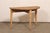 A Swedish single wooden demi-lune table from the early 20th century. This nicely-sized antique table from Sweden has a...