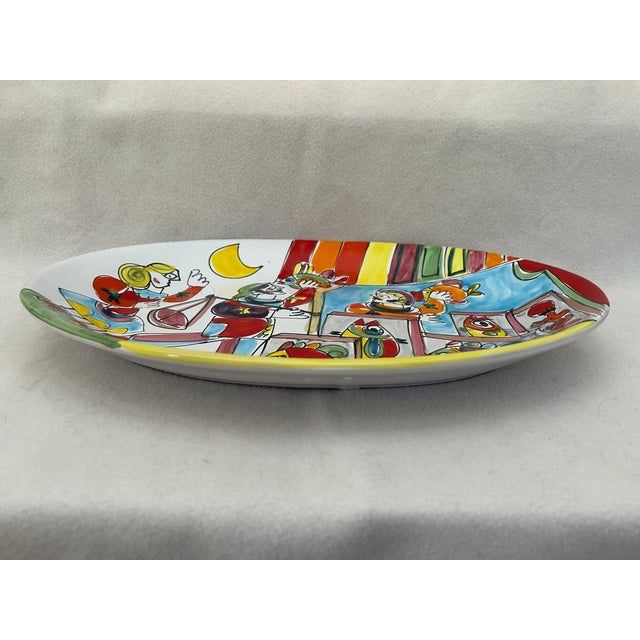 A vibrant piece of vintage Italian art pottery, this La Musa hand-painted oval serving platter captures the whimsical...
