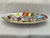 A vibrant piece of vintage Italian art pottery, this La Musa hand-painted oval serving platter captures the whimsical...