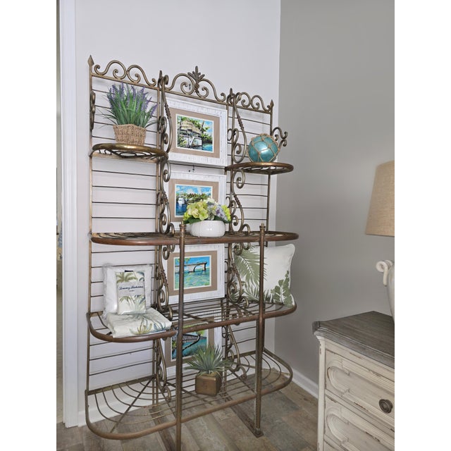 Antique French iron and brass boulangerie baker’s rack featuring decorative scrollwork, brass elements, and beautifully...