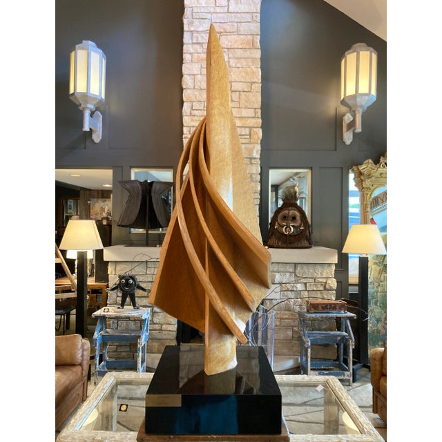 Fanned Sail Form Wooden Slat Abstract Sculpture on Black Plinth Titled Serendipity by Michi Raphael.