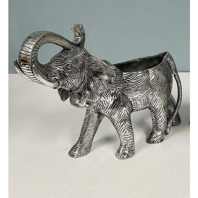 A striking silver-plated elephant form wine or champagne cooler beautifully modelled with its trunk raised aloft in a...