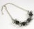 This is part of Chairish’s Costume Jewelry assortment. Strongly graphic prong set grey "pearls" and black and silver...