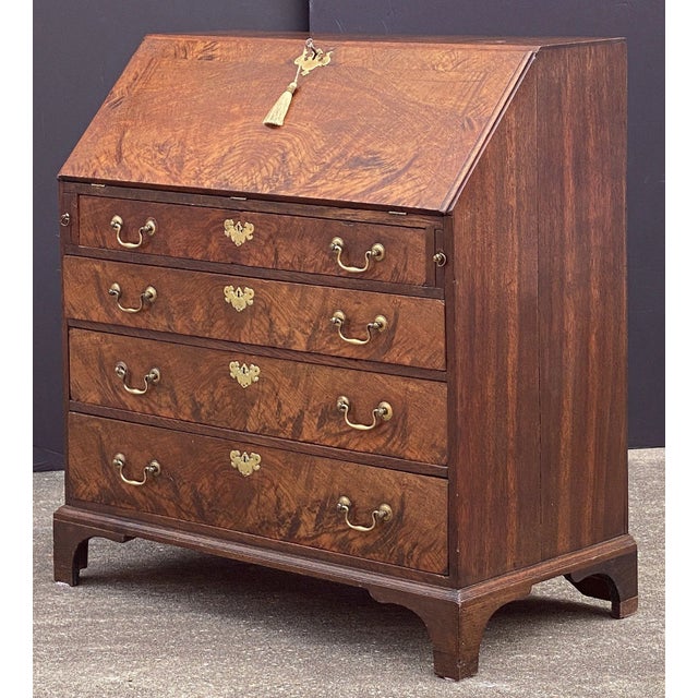 A fine George III slant top desk or bureau secretary chest of elm, oak and padouk woods, c.1780 - an inlaid slant front...
