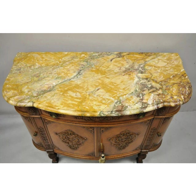 Antique French Louis XV Style Carved Walnut Marble Top Buffet Sideboard Cabinet. Item features a shaped rouge marble top,...