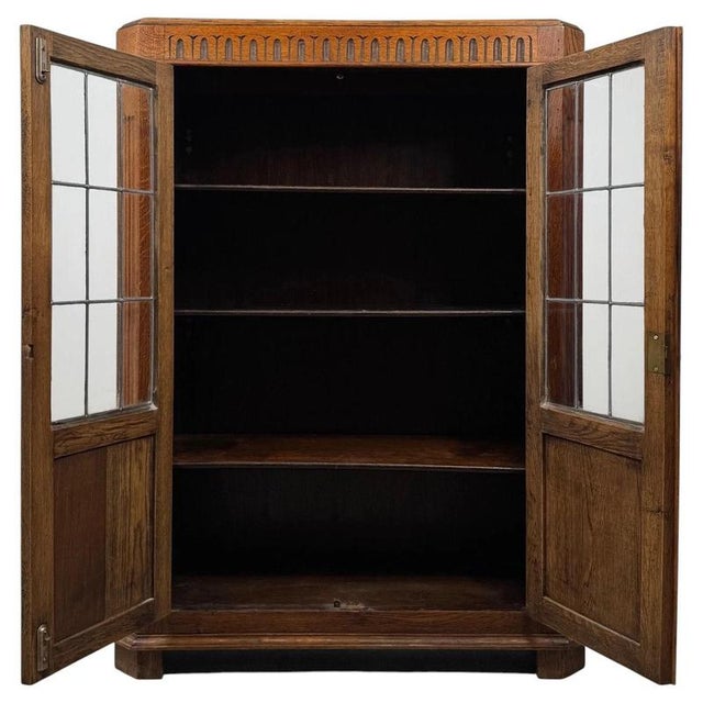 A striking and beautifully detailed 20th-century oak glazed display cabinet, combining traditional craftsmanship, generous...
