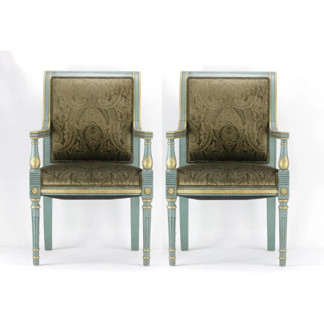 A pair of vintage hand-carved armchairs with timeless shapes inspired by classicism. Each chair is upholstered in high...