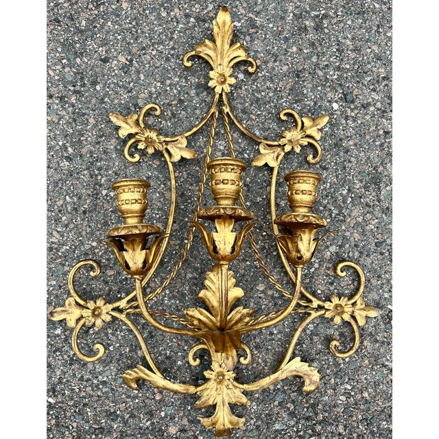 A late 1880s Italian antique wall candle holder sconce. The scroll design has 3 arms for taper candles. This fine ormolu...