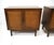 A pair of dark walnut two door nightstand chests with woven caned door fronts having key styled pulls. Inside there is one...