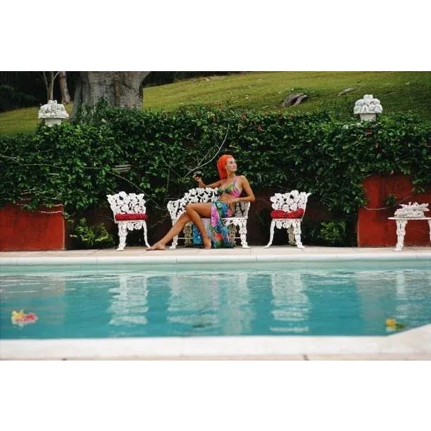Lounging In Bermuda 1969 A woman relaxes with a drink by a swimming pool in Bermuda, November 1969. Slim Aarons Slim...