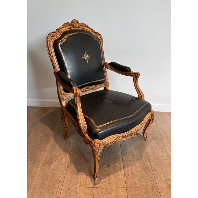 This beautiful and decorative Queen's armchair is made of carved walnut and upholstered in black leather with iron-gilt...