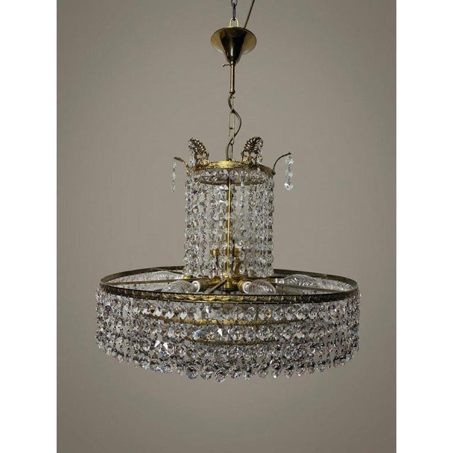 A real vintage highlight from the 1960s, this exquisite crystal glass and brass chandelier creates a warm, inviting...