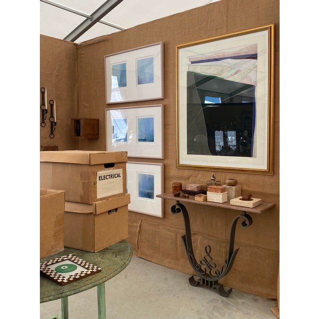 Wall-mounted iron base marble top console table. Elegant scroll base with warm-toned, salmon-colored marble top. Overall...