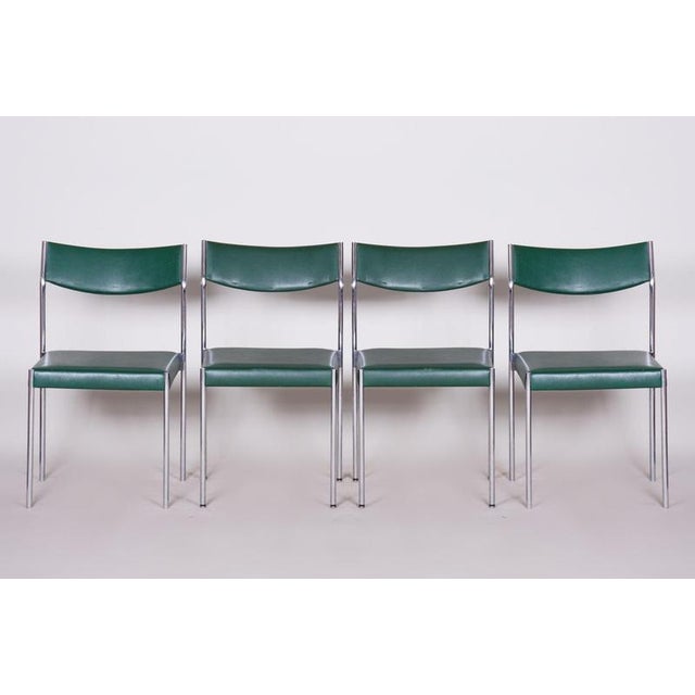 This elegant and characteristically shaped set of four chairs in the spirit of Mid-Century aesthetics dates from the 1950s...