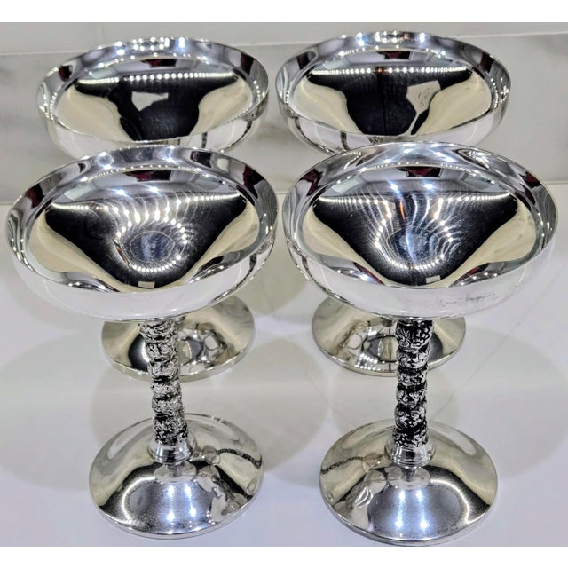 Elevate your bar cart, wedding toast, or holiday table with this striking set of four vintage silver-plated champagne...