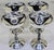 Elevate your bar cart, wedding toast, or holiday table with this striking set of four vintage silver-plated champagne...