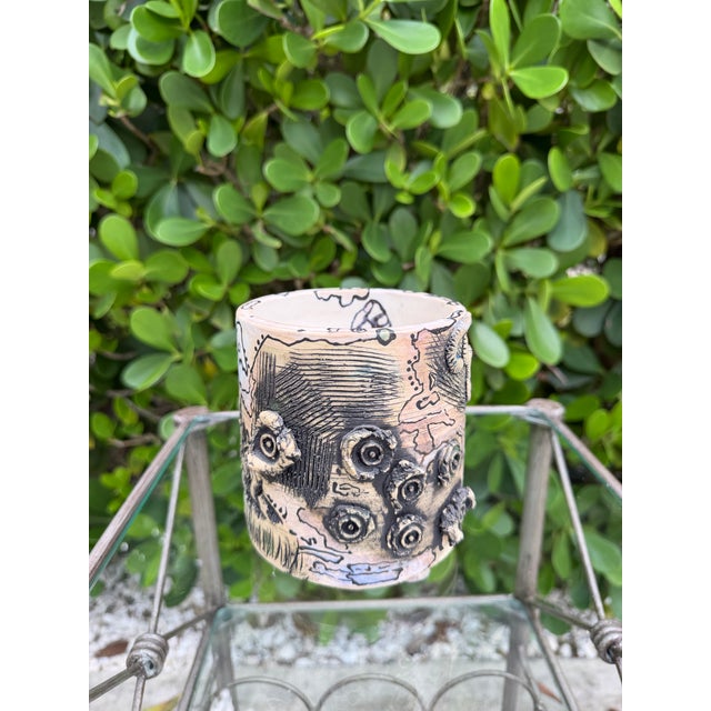 Vintage signed studio pottery vessel featuring an expressive abstract design with hand-drawn and incised decoration,...