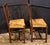 Pair of early 19th century Italian rustic neoclassical side chairs. Square backs with carved urn backsplats. Rush seats in...