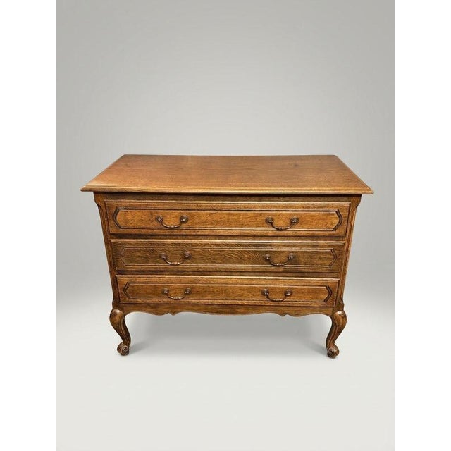 A seriously handsome early 20th-century French chest of drawers crafted in rich, character-filled stained oak. Featuring...