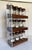 Here is a wonderful, mid-century modern spice rack featuring 12 glass bottles with wood tops, beautifully displayed in a...