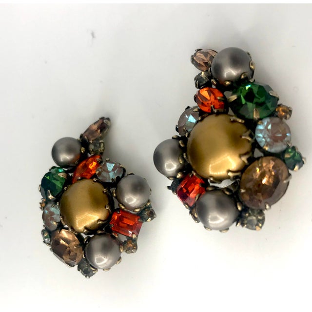 This is part of Chairish’s Costume Jewelry assortment. These are a unique pair of Kramer clip on earrings with rich colors...