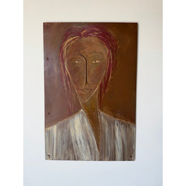 Unique vintage mixed media wall art featuring a stylized female portrait rendered on a metal panel. This expressive piece...