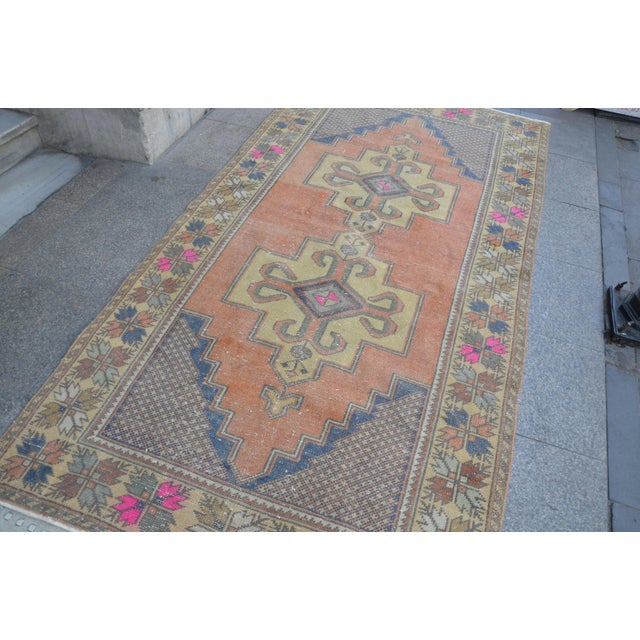 This is a vintage Turkish Oushak rug from the 1960s. The piece was hand-knotted
