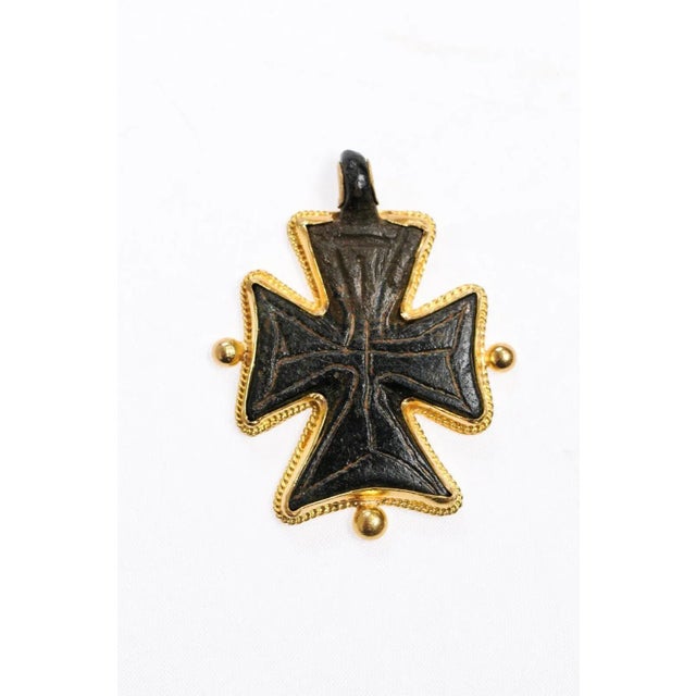 This is part of Chairish’s Fine Jewelry assortment. A bronze cross pendant from the Byzantine Era trimmed with 21K gold....