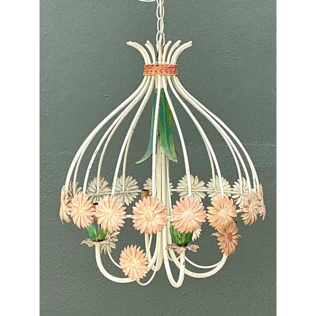 Exuding mid-century botanical charm, this vintage hand-painted metal tole chandelier features a graceful, bell-shaped cage...