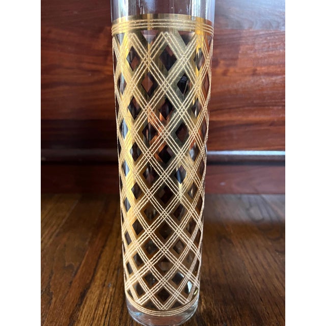 The sky-scraper martini pitcher is beautifully shiny and in excellent vintage condition. The pattern of intense gold,...