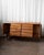 Striking mid-century sideboard crafted in warm butternut, showcasing Bevelacque’s signature geometric detailing. The...