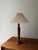 Sculptural wooden table lamp with pleated lampshade. A lamp that instantly brings tranquility to the room. The turned...