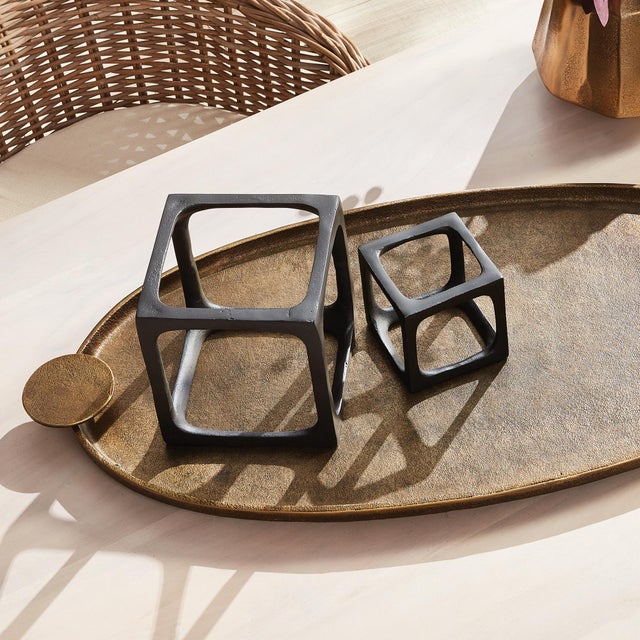 What is better than a simple three dimensional cast aluminum rendition of a square? A set of two. These cubist sculptures...