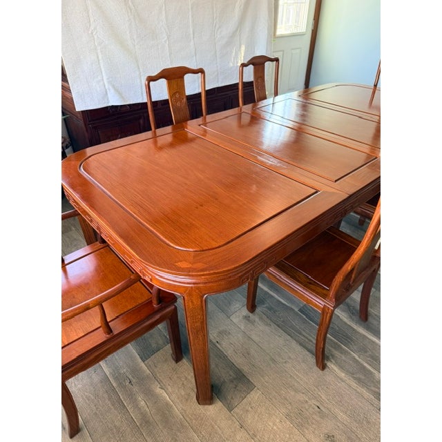 Exhibiting its pleasing, simple lines in a distinct Ming style, this exquisite dining set is intricately carved in Chinese...