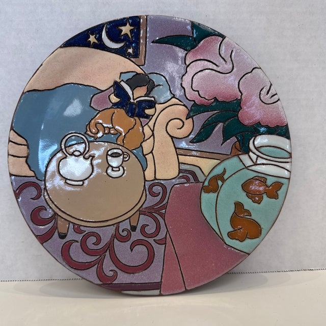 Vintage ceramic plate by Judy Miller, 1987 depictiong a woman cozied up with her cat and a cup of coffee. Signed and dated...