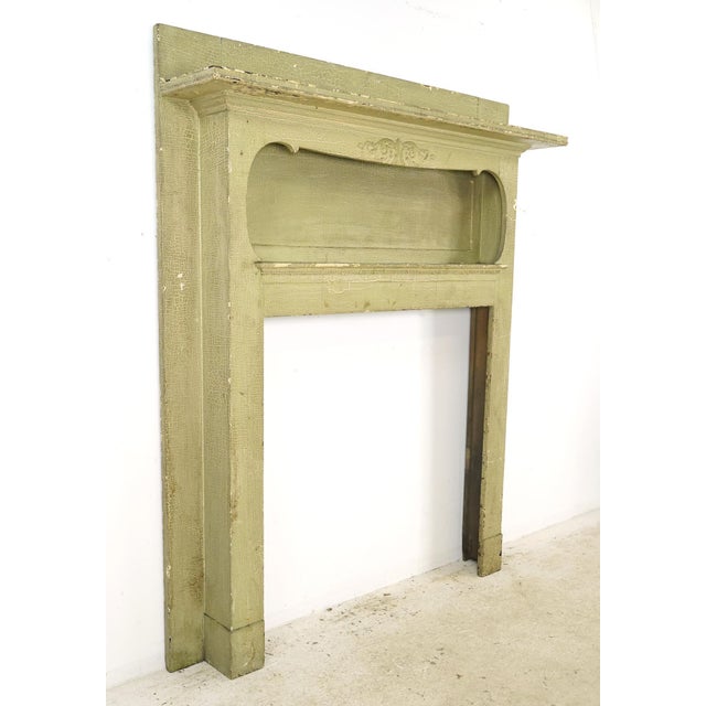 Traditional style full sized wooden mantel with an enclosed shadowbox top shelf and raised decorative wood detail at the...