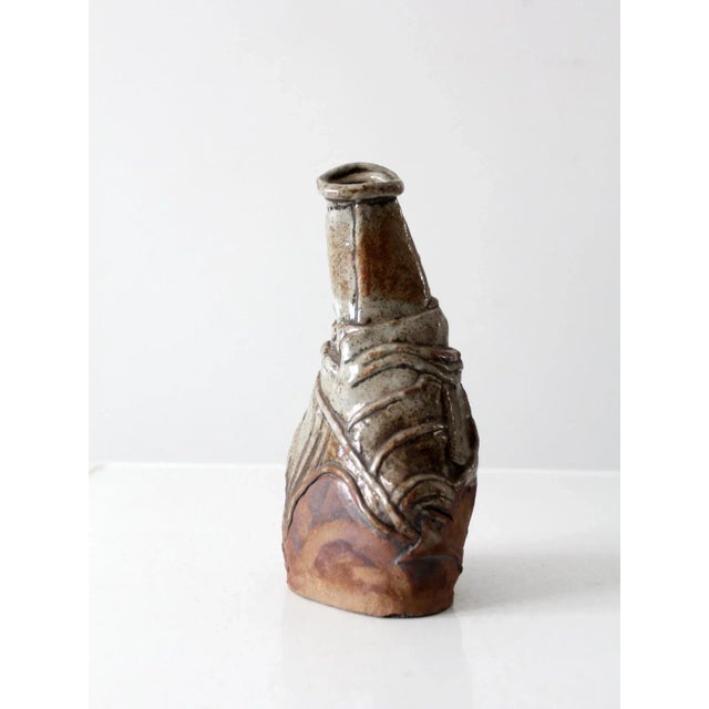 This is a vintage studio pottery vase. Signed by the artist, the handmade free form slab pottery vase has etched and...