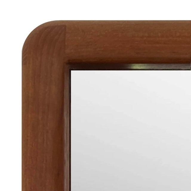 A timeless classic - this beautiful Danish modern mirror was crafted by D-Span sometime in the 1970's. Teak with curved...