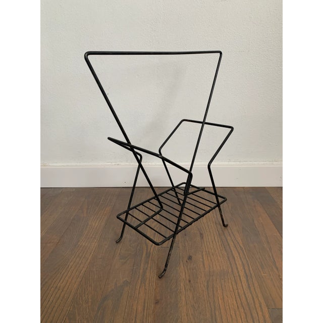 Vintage minimal mid-century modern wire magazine rack with angular lines.