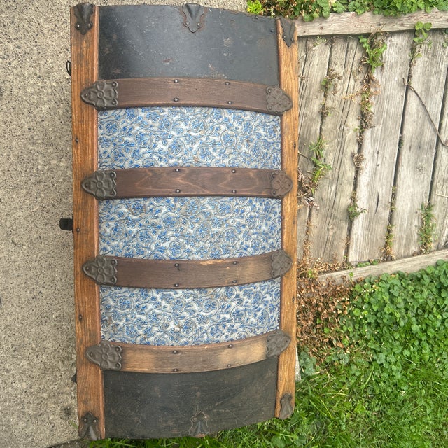 Antique traveling trunk with desirable blue on embossed floral design; all original; leather handles intact; no key;...