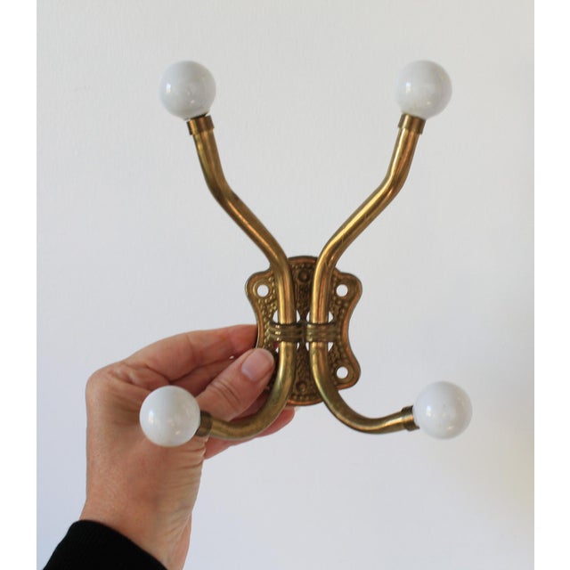 Vintage brass and white porcelain 4-hook wall mount coat and hat hanger, made in Taiwan. Minor age wear. Hardware not...