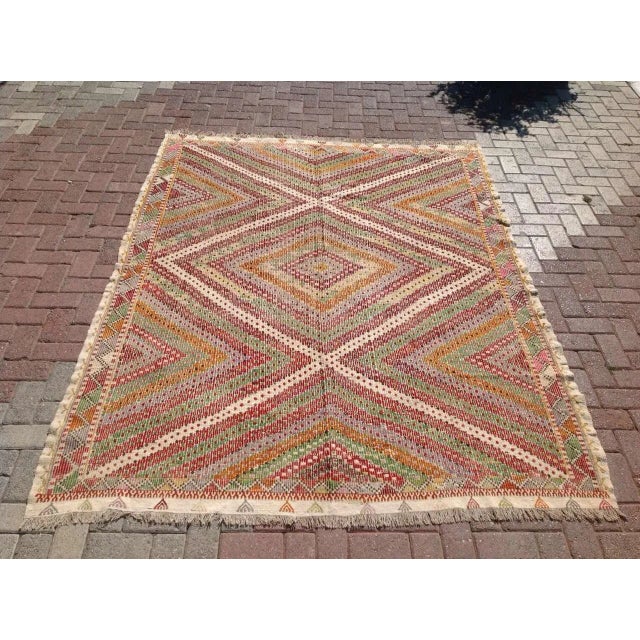 This beautiful, vintage, handwoven kilim is approximately 60 years old. It is handmade of wool in all natural colors.. It...