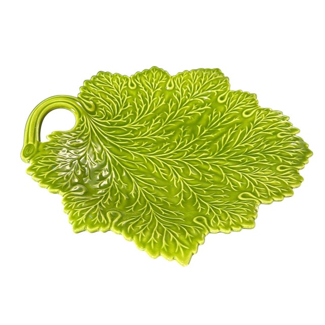 This plate combines the artistry of majolica with the naturalistic elegance of cabbage ware, resulting in a piece that is...