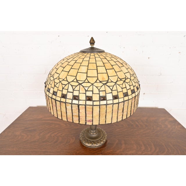 A gorgeous Arts & Crafts table lamp with jeweled stained caramel glass shade In the manner of Tiffany Studios USA, Late...