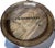 Round decorative wine-barrel style serving tray crafted from wood staves with a raised rim and metal banding, designed to...