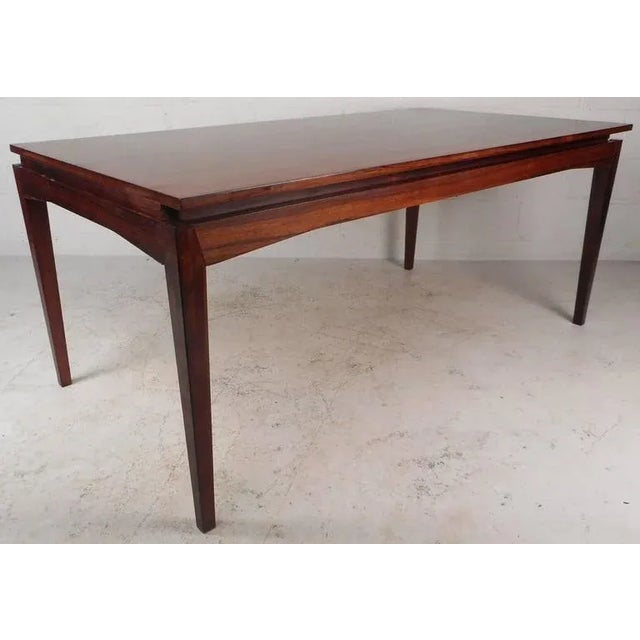 Elegant vintage modern dining table features a unique draw-leaf design and comes with two leaves (only one shown in...