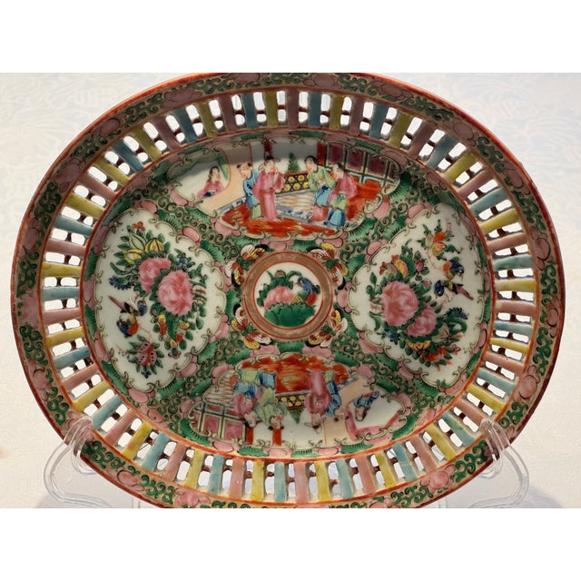 This 1920s Chinese Export Rose Medallion dish has an elaborately reticulated border with hand enameled figural and...